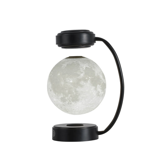 Black moon LED night light with glowing floating globe and round magnetic base
